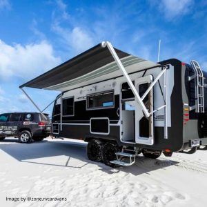 caravan hitched to a ute and parked on a white sand beach